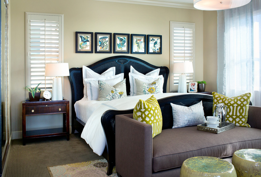 This is an example of a transitional bedroom in Los Angeles with beige walls and carpet.
