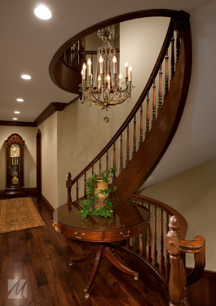 Traditional wood curved staircase in Salt Lake City with wood risers.