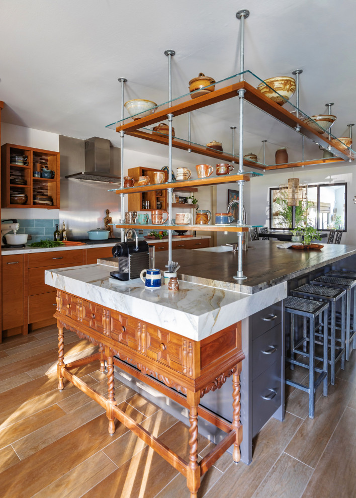 Photo of a midcentury open plan kitchen in Houston with with island, open cabinets, medium wood cabinets, quartzite benchtops, green splashback, ceramic splashback, stainless steel appliances and white benchtop.