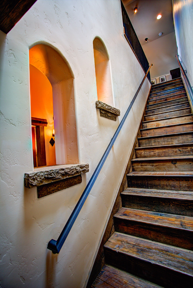 Inspiration for a large rustic wooden straight staircase remodel with wooden risers