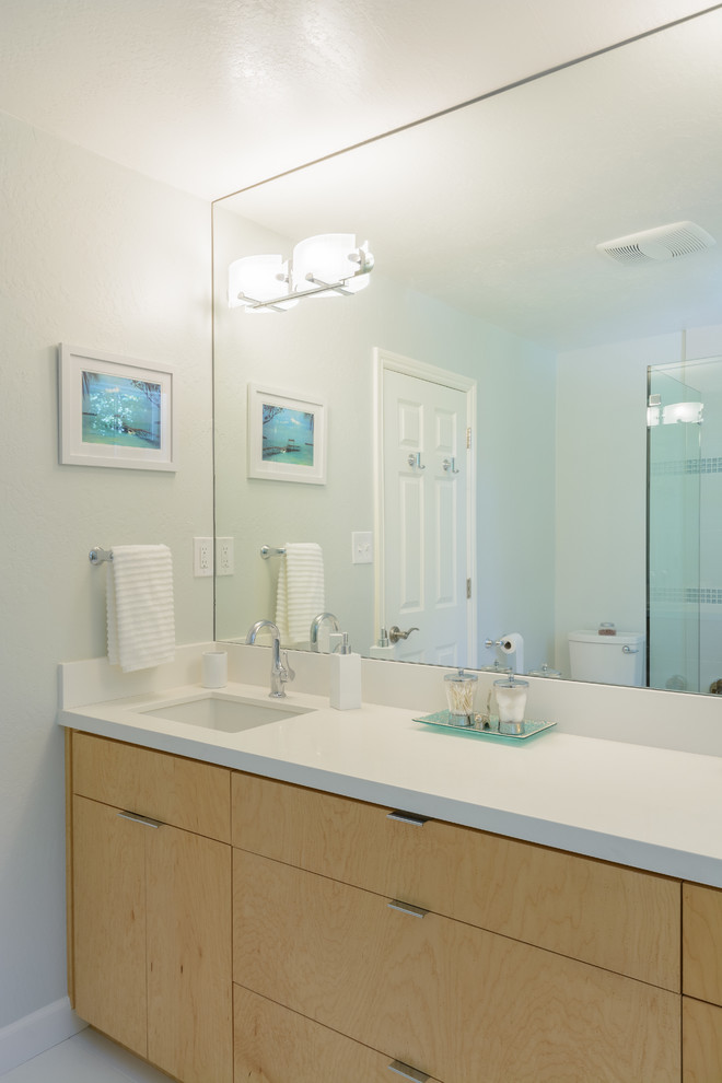 Design ideas for a mid-sized contemporary master bathroom in San Francisco with an undermount sink, flat-panel cabinets, light wood cabinets, engineered quartz benchtops, white tile, porcelain tile, white walls and porcelain floors.