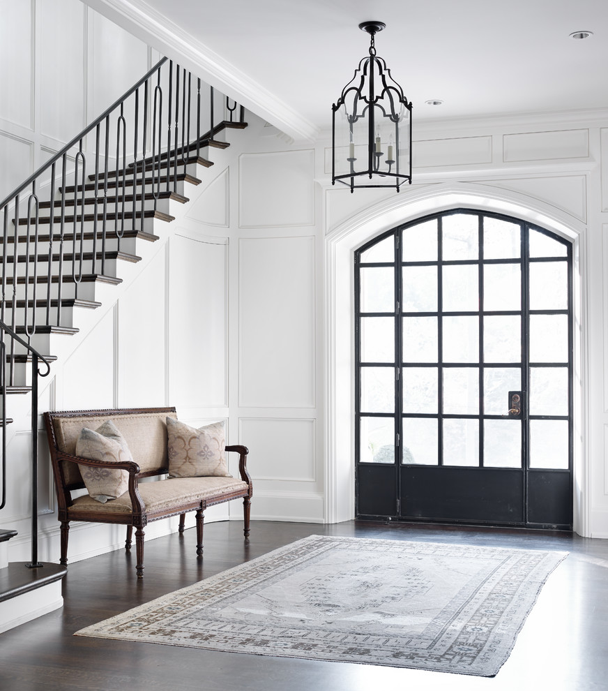 Example of a transitional dark wood floor foyer design in Atlanta with white walls