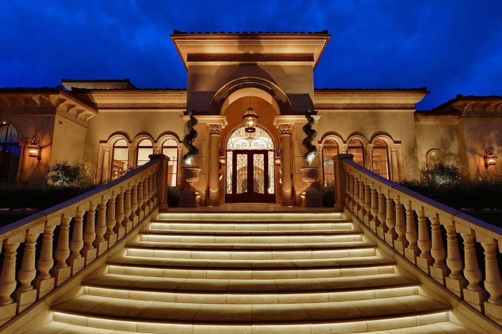 Example of a tuscan double front door design in San Diego with a glass front door