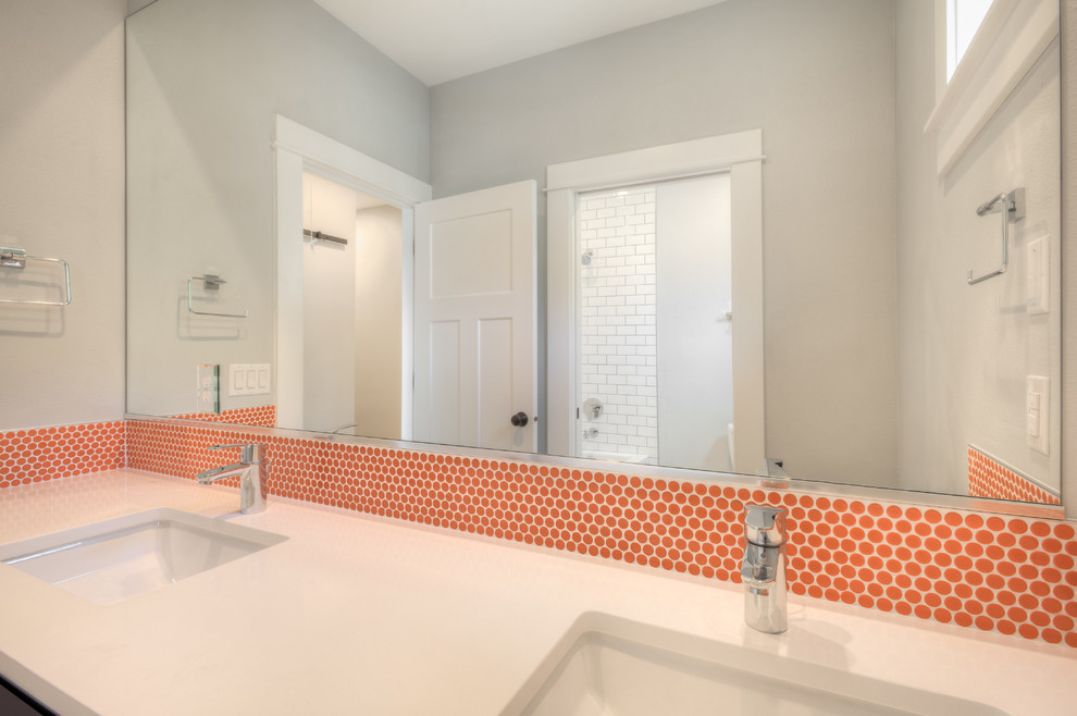 Photo of a small transitional kids bathroom in Seattle with shaker cabinets, blue cabinets, a two-piece toilet, orange tile, mosaic tile, grey walls, mosaic tile floors, an undermount sink, engineered quartz benchtops and grey floor.