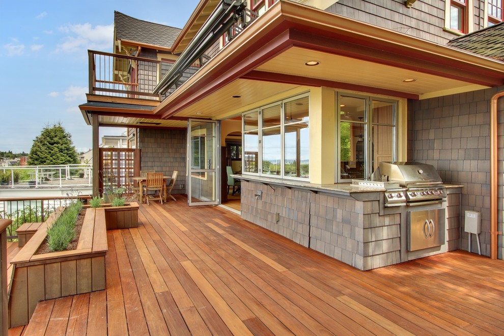 Design ideas for an arts and crafts deck in Seattle with a roof extension.