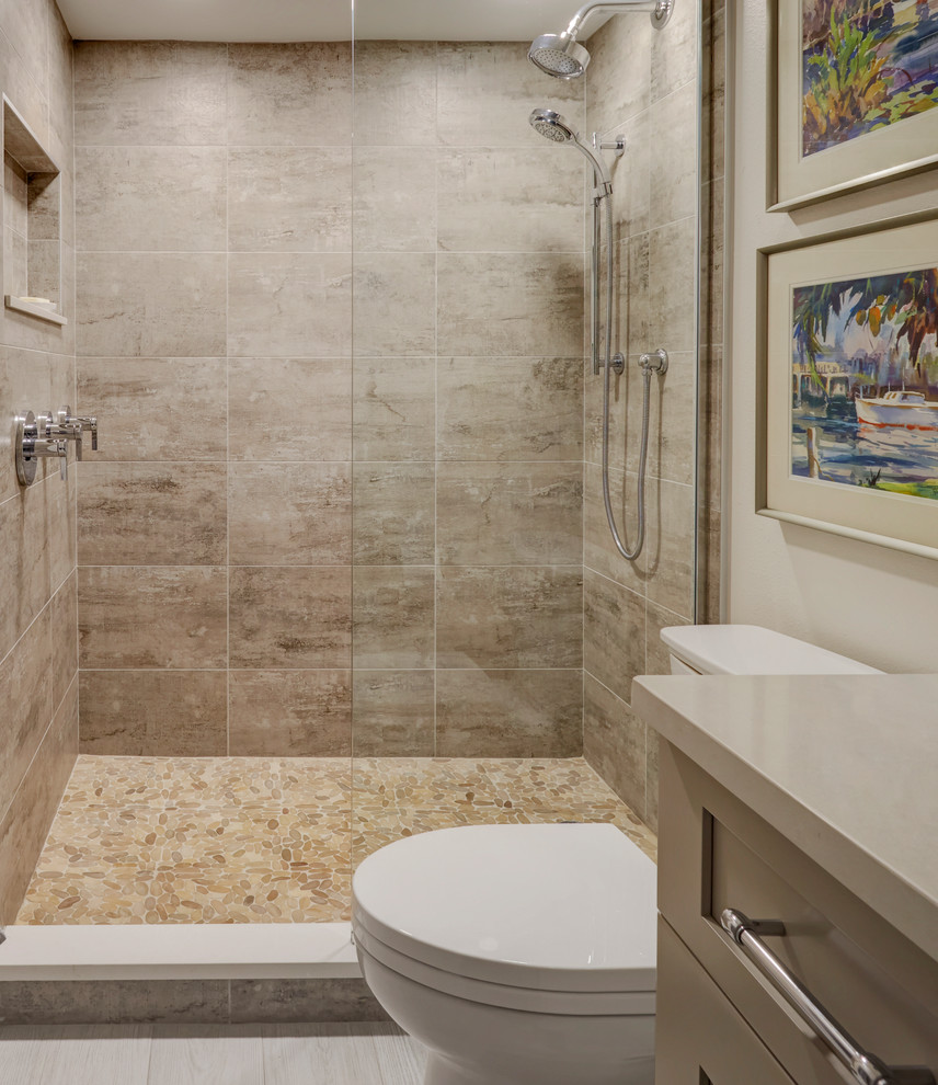 This is an example of a small beach style 3/4 bathroom in Other with shaker cabinets, beige cabinets, an alcove shower, a two-piece toilet, beige tile, wood-look tile, beige walls, porcelain floors, an undermount sink, engineered quartz benchtops, grey floor, an open shower, beige benchtops, a single vanity and a built-in vanity.