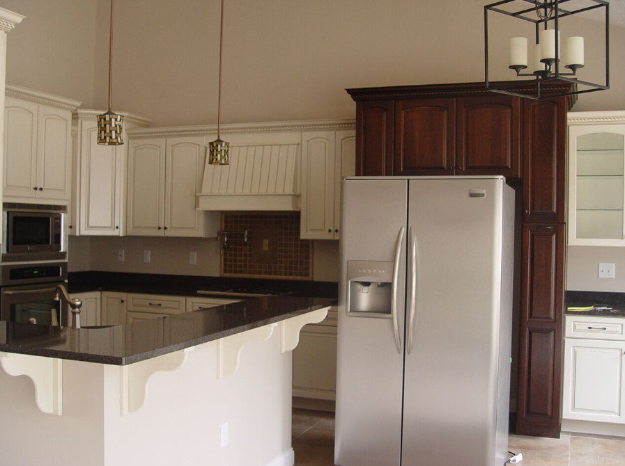 Example of a mid-sized classic porcelain tile and beige floor open concept kitchen design with a double-bowl sink, raised-panel cabinets, white cabinets, granite countertops, stainless steel appliances and an island