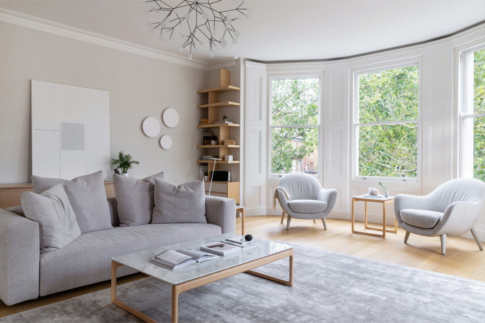 Inspiration for a scandinavian living room in London with grey walls, light hardwood floors and beige floor.
