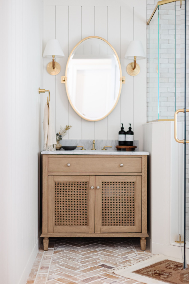 Inspiration for a mid-sized transitional bathroom in Orlando with light wood cabinets, a corner shower, a two-piece toilet, white tile, terra-cotta tile, white walls, brick floors, marble benchtops, red floor, a hinged shower door, grey benchtops, a single vanity, a freestanding vanity and planked wall panelling.