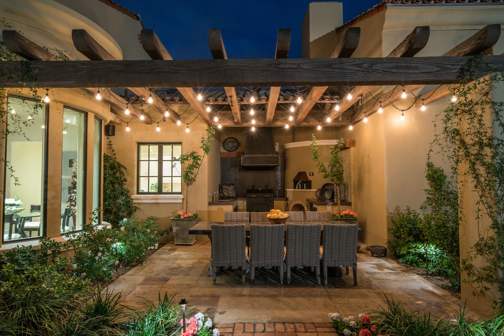 This is an example of a mid-sized backyard patio in Phoenix with a pergola.