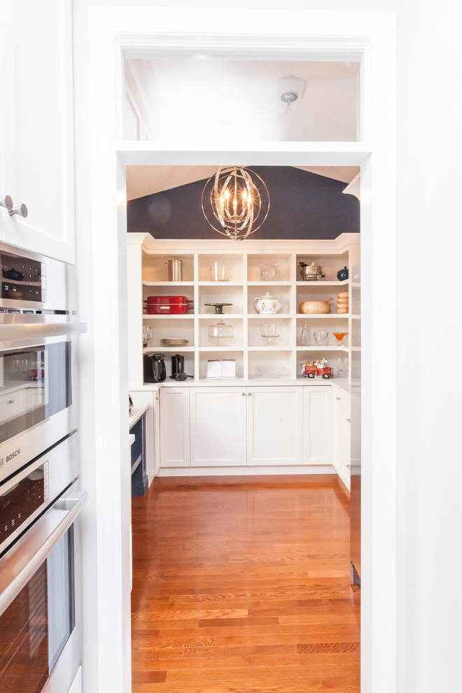 Large transitional u-shaped dark wood floor and brown floor kitchen pantry photo in Toronto with recessed-panel cabinets, white cabinets, quartz countertops, gray backsplash, stainless steel appliances, an island and white countertops