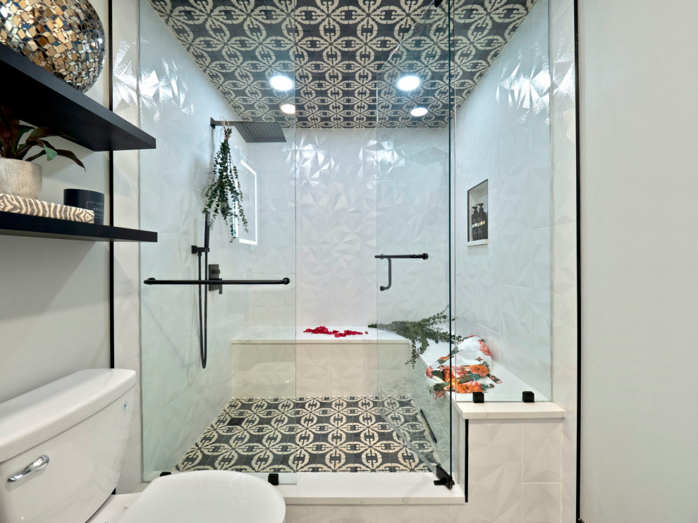Inspiration for a large bohemian wet room bathroom in Other with glass-front cabinets, black cabinets, a two-piece toilet, black and white tiles, cement tiles, grey walls, concrete flooring, a wall-mounted sink, quartz worktops, black floors, a hinged door, white worktops, a shower bench, a single sink and a floating vanity unit.