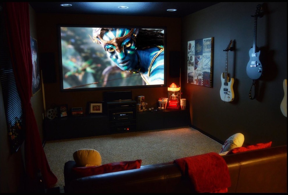 Inspiration for a mid-sized modern enclosed home theatre in Other with black walls, carpet and a wall-mounted tv.