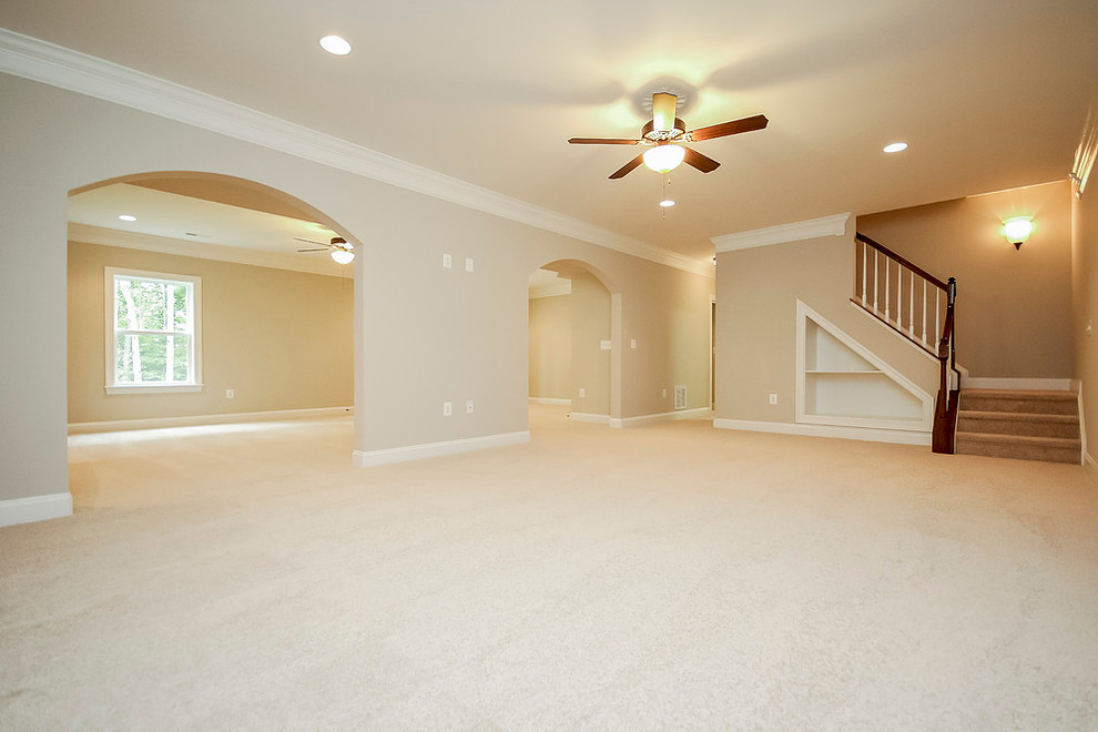 Design ideas for a large transitional fully buried basement in Other with beige walls, carpet, no fireplace and beige floor.