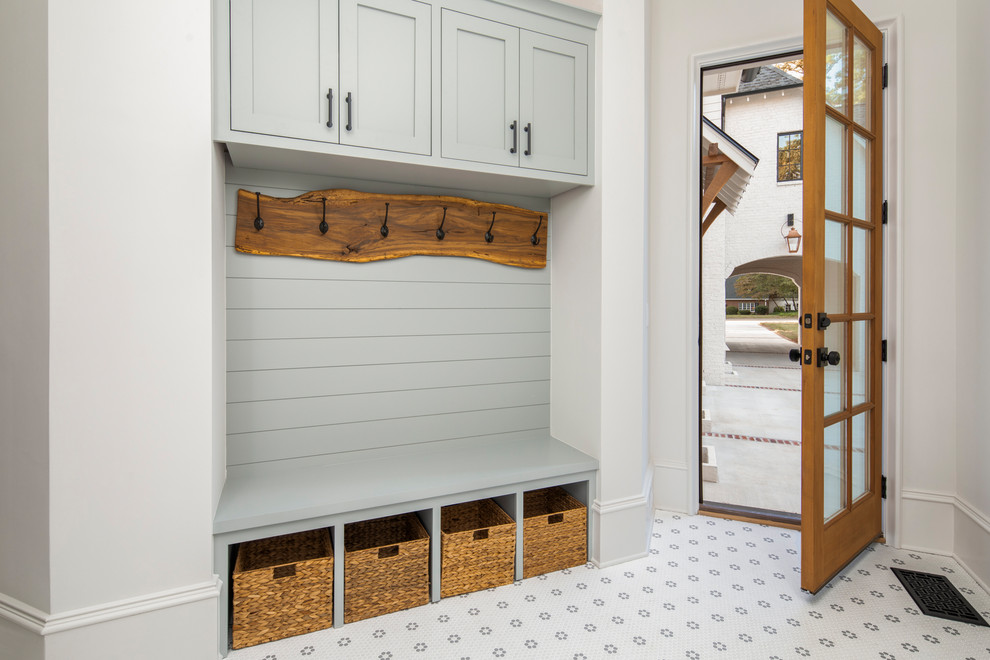 Inspiration for a mid-sized transitional mudroom in Charlotte with white walls, porcelain floors, a single front door and a medium wood front door.