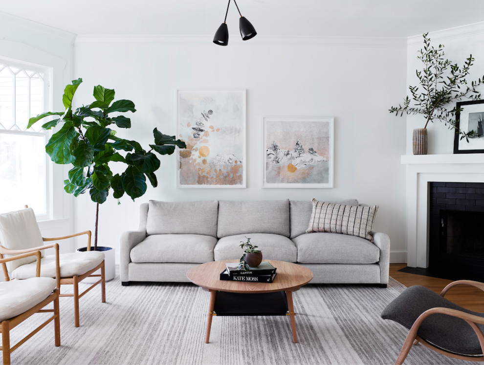 Inspiration for a mid-sized scandinavian formal enclosed living room in San Francisco with white walls, medium hardwood floors, a corner fireplace, a tile fireplace surround, no tv and brown floor.