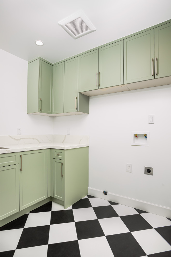 Small transitional l-shaped dedicated laundry room in Los Angeles with an undermount sink, shaker cabinets, green cabinets, quartz benchtops, white splashback, engineered quartz splashback, white walls, ceramic floors, a side-by-side washer and dryer, multi-coloured floor and white benchtop.