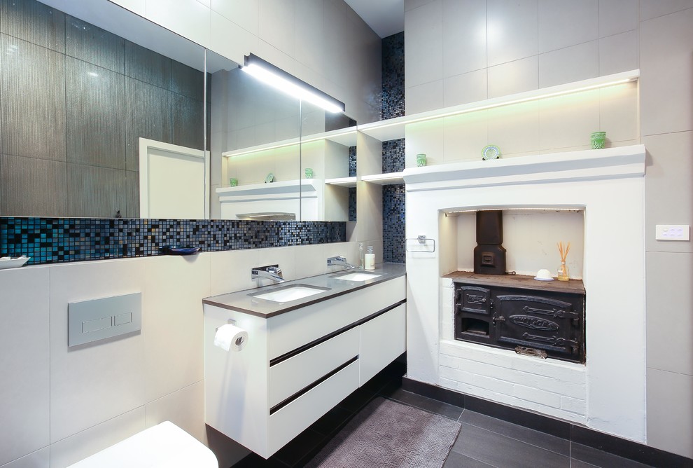 This is an example of a mid-sized contemporary master bathroom in Sydney with flat-panel cabinets, white cabinets, blue tile, white tile, an undermount sink and an open shower.