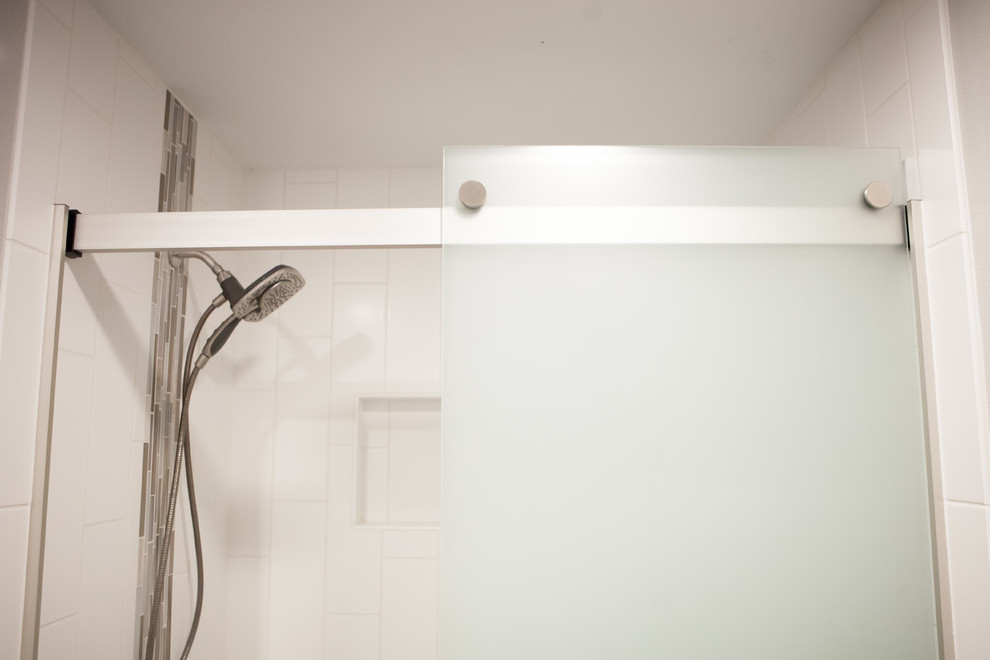 Alcove bathtub - transitional master gray tile ceramic tile alcove bathtub idea with recessed-panel cabinets, dark wood cabinets, gray walls, an undermount sink and quartz countertops