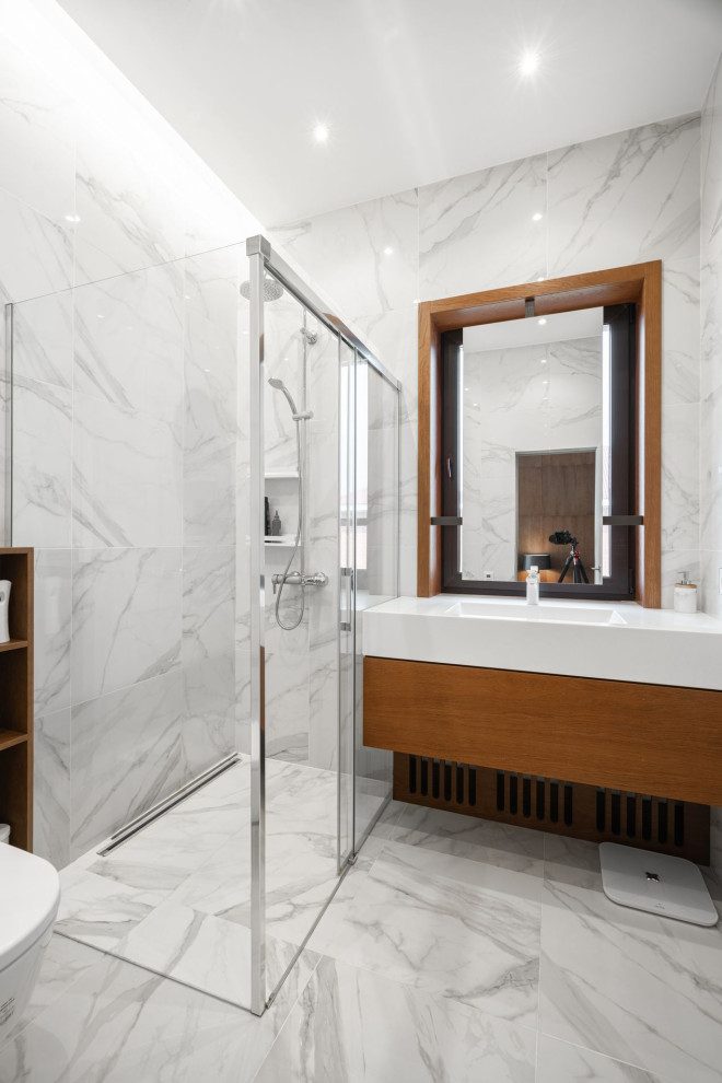 This is an example of a large contemporary shower room bathroom in Other with flat-panel cabinets, medium wood cabinets, a corner shower, a bidet, white tiles, porcelain tiles, white walls, porcelain flooring, solid surface worktops, white floors, white worktops, a single sink and a floating vanity unit.