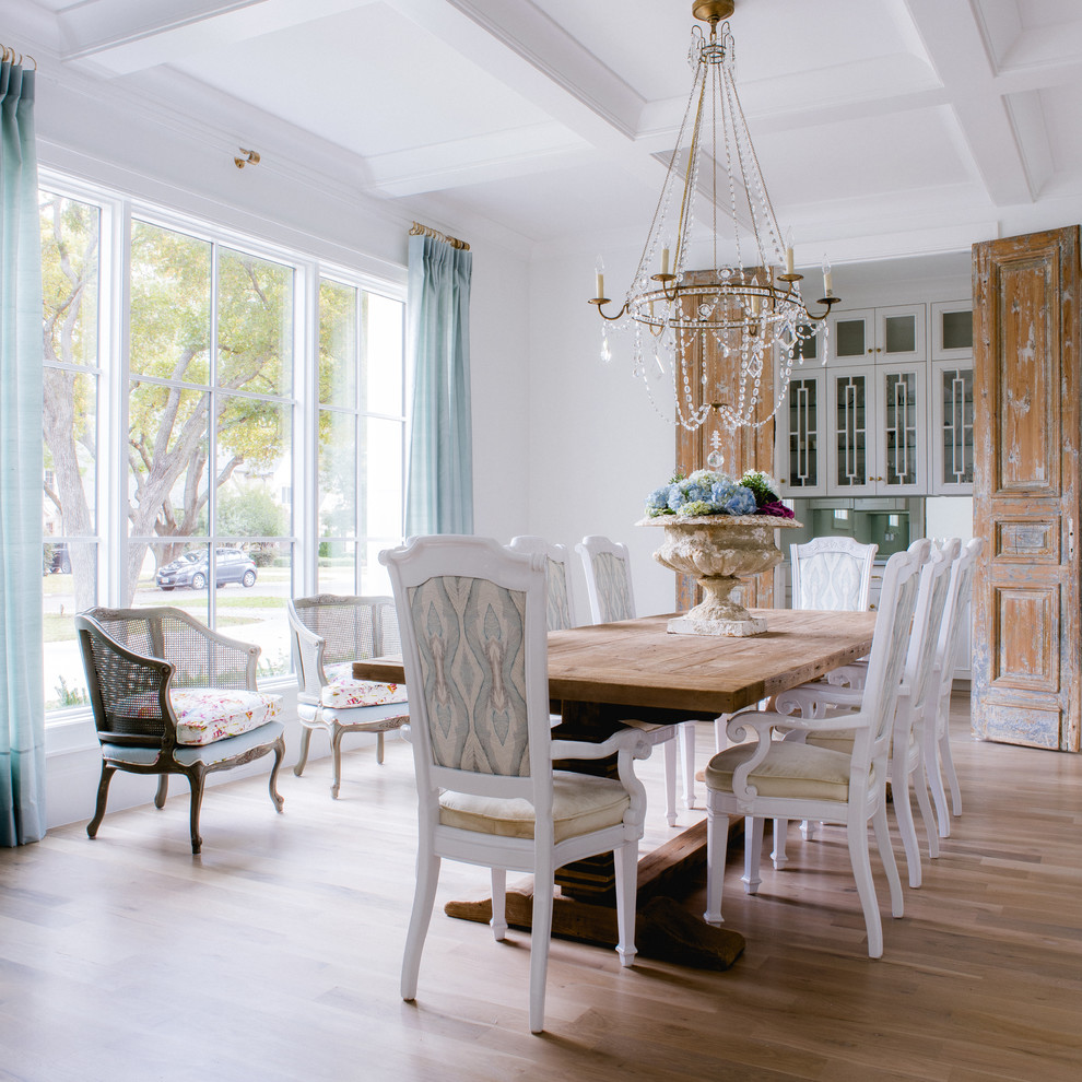Inspiration for a traditional dining room in Dallas with white walls and light hardwood floors.