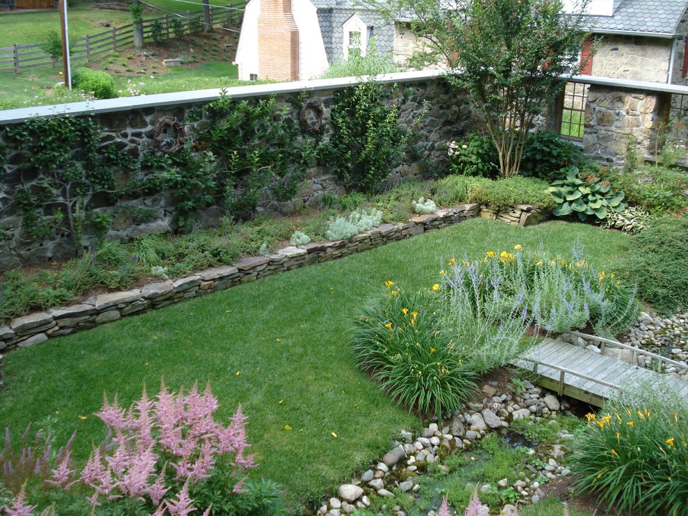 Traditional garden in Baltimore with a water feature.