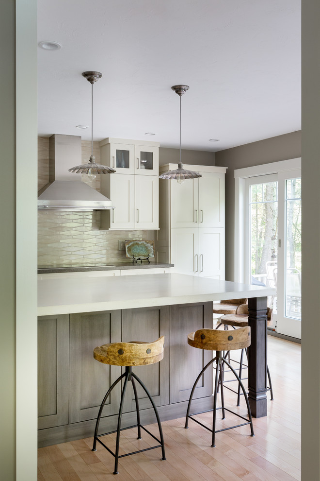 This is an example of a mid-sized transitional kitchen pantry in Boston with a single-bowl sink, shaker cabinets, white cabinets, concrete benchtops, beige splashback, mosaic tile splashback, stainless steel appliances, light hardwood floors and with island.