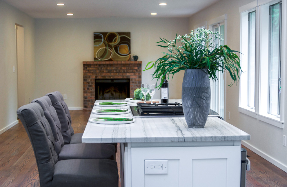 Inspiration for a large transitional galley medium tone wood floor and brown floor open concept kitchen remodel in Seattle with an undermount sink, shaker cabinets, white cabinets, quartz countertops, blue backsplash, subway tile backsplash, stainless steel appliances, an island and multicolored countertops