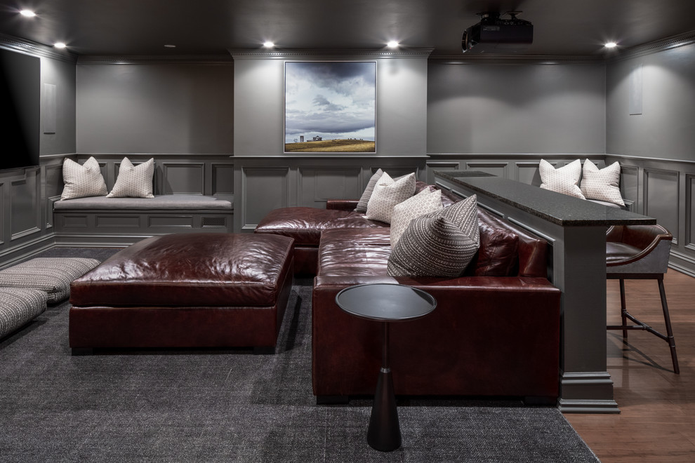 Photo of a country enclosed home theatre in Boston with grey walls, a wall-mounted tv, dark hardwood floors and brown floor.