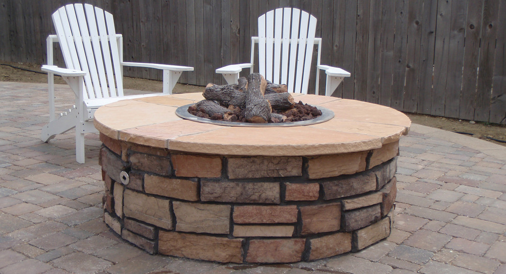 Mid-sized backyard concrete paver patio photo in Denver with a fire pit and no cover