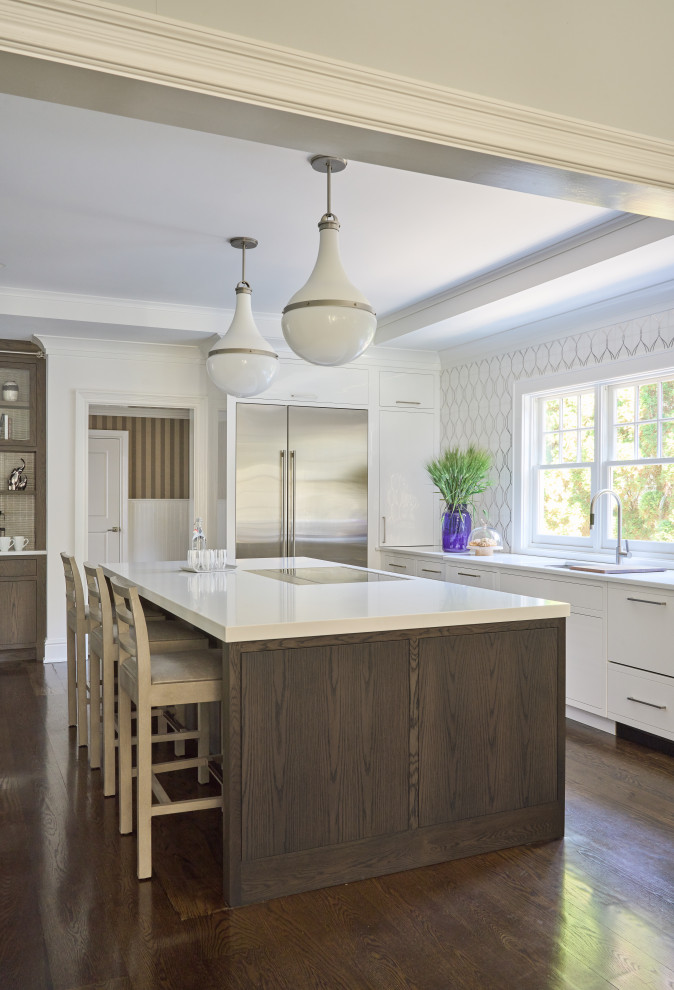 Large transitional u-shaped dark wood floor and brown floor enclosed kitchen photo in New York with an undermount sink, flat-panel cabinets, dark wood cabinets, quartz countertops, white backsplash, mosaic tile backsplash, stainless steel appliances, an island and white countertops