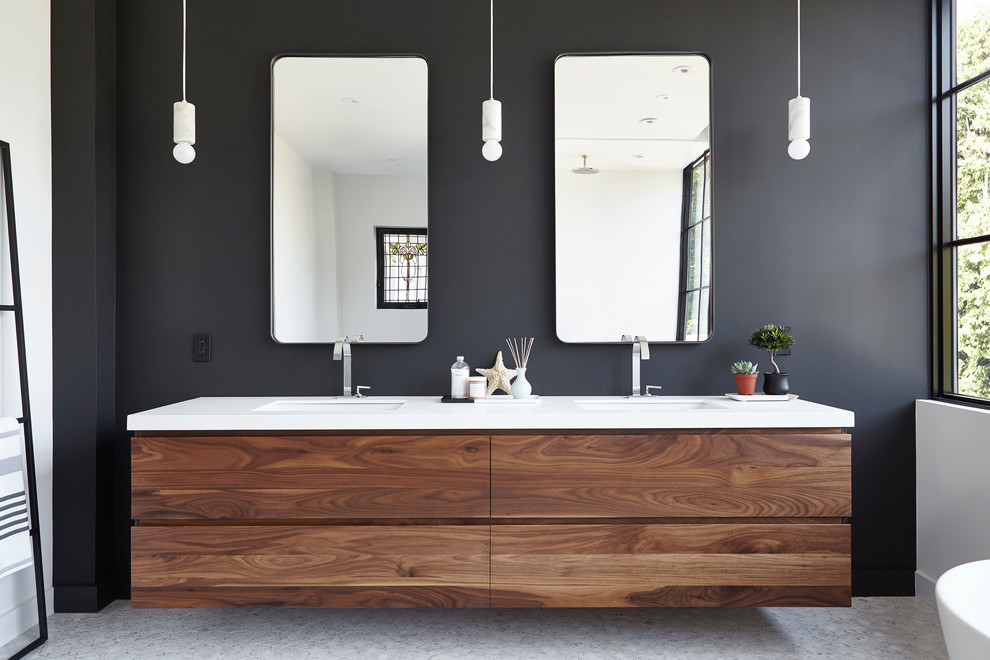 This is an example of a mid-sized transitional master bathroom in Toronto with medium wood cabinets, a freestanding tub, black walls, mosaic tile floors, engineered quartz benchtops and white floor.