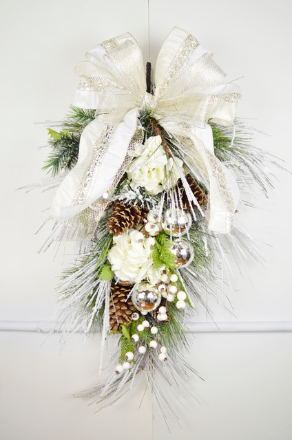 Evergreen swag with hydrangeas, berries, silver ornaments, and ribbon