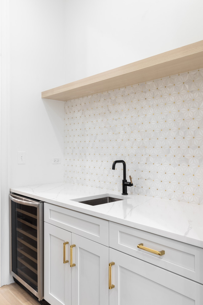 Design ideas for a small single-wall wet bar in San Diego with a submerged sink, shaker cabinets, white cabinets, engineered stone countertops, white splashback, porcelain splashback, vinyl flooring, brown floors and white worktops.