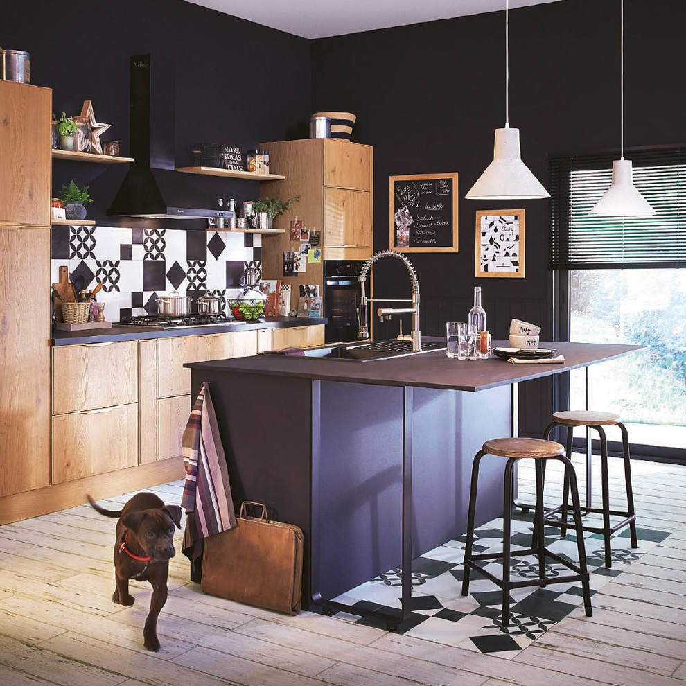 This is an example of a mid-sized industrial galley eat-in kitchen in Lille with a drop-in sink, medium wood cabinets, multi-coloured splashback, panelled appliances and with island.