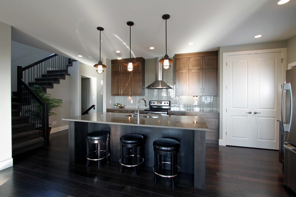 Photo of an eclectic l-shaped kitchen in Other with an undermount sink, shaker cabinets, dark wood cabinets, quartzite benchtops, white appliances, dark hardwood floors and multiple islands.
