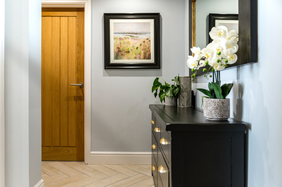 This is an example of a mid-sized contemporary hallway in Other with grey walls, ceramic floors, grey floor and panelled walls.