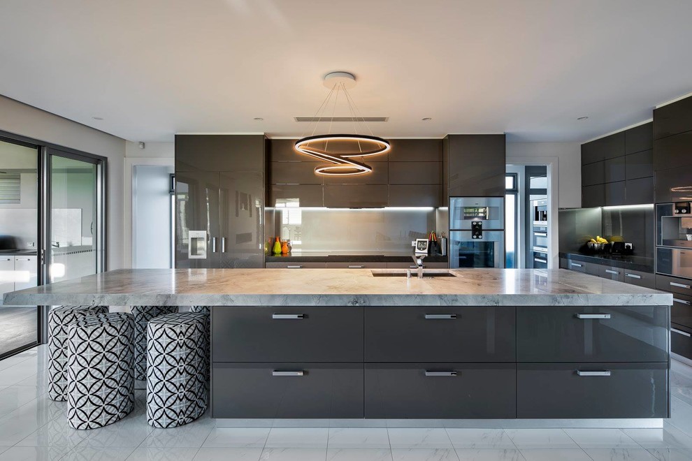 Photo of a large contemporary galley eat-in kitchen in Adelaide with a drop-in sink, brown cabinets, green splashback, glass tile splashback, stainless steel appliances, porcelain floors, with island, louvered cabinets, marble benchtops, white floor and grey benchtop.