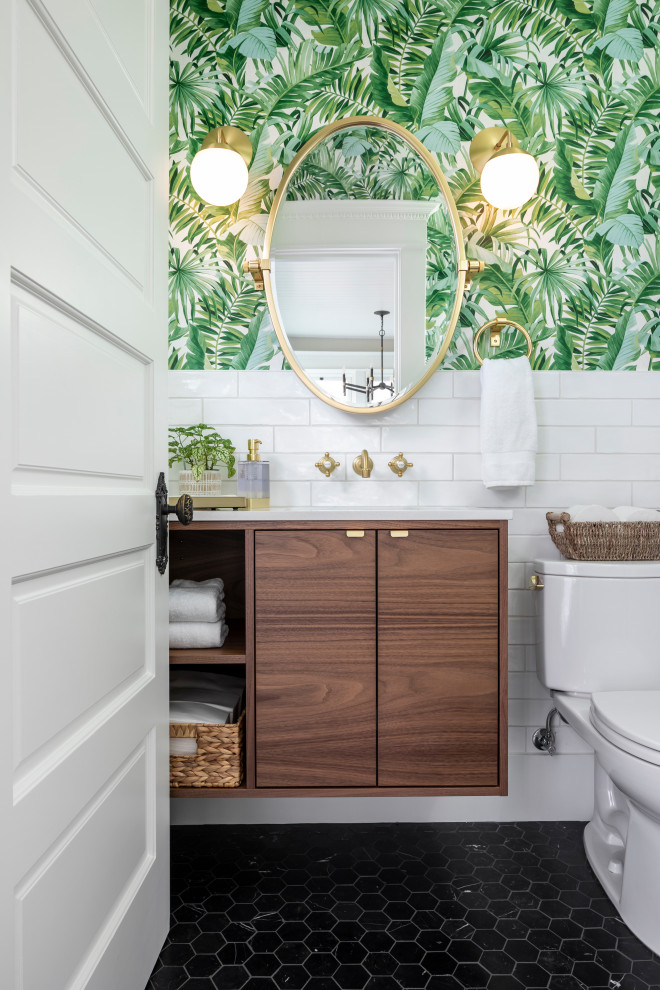 Small eclectic bathroom in Seattle with flat-panel cabinets, medium wood cabinets, a two-piece toilet, white tile, ceramic tile, green walls, marble floors, an undermount sink, engineered quartz benchtops, black floor, white benchtops, a single vanity, a floating vanity and wallpaper.