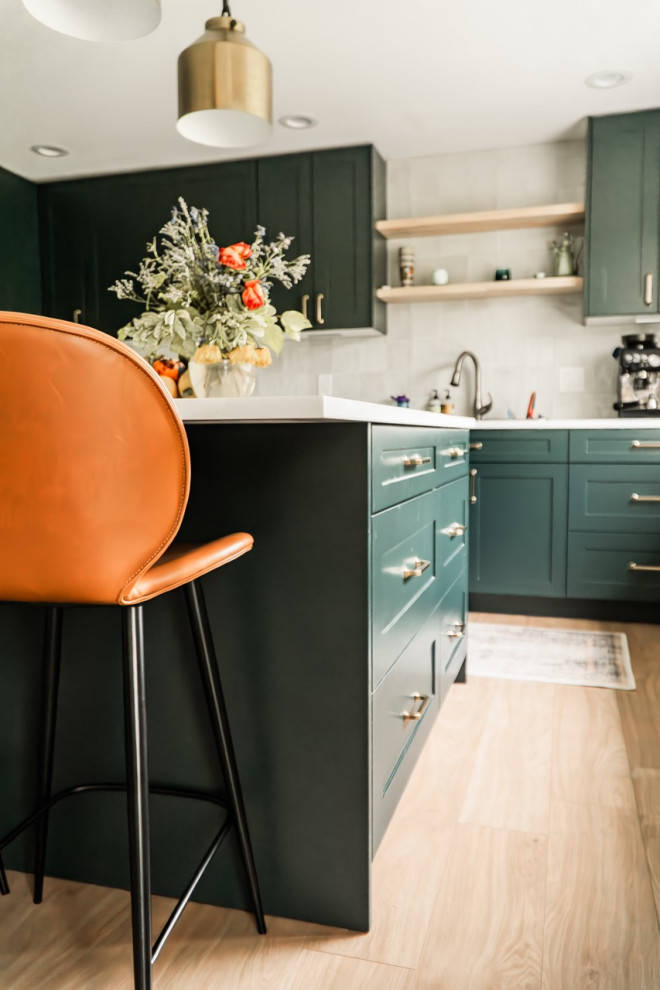Example of a large trendy l-shaped light wood floor and beige floor kitchen design in Seattle with shaker cabinets, turquoise cabinets, quartzite countertops, white backsplash, ceramic backsplash, stainless steel appliances, an island and white countertops