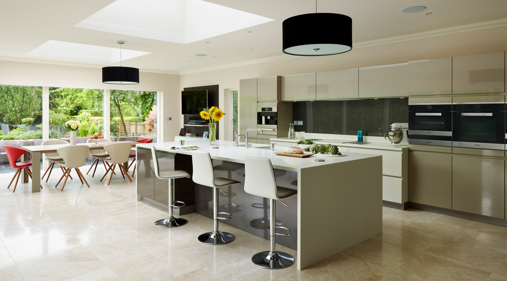 Inspiration for a large contemporary u-shaped open plan kitchen in Essex with an undermount sink, flat-panel cabinets, beige cabinets, grey splashback, stainless steel appliances, ceramic floors, a peninsula and beige floor.