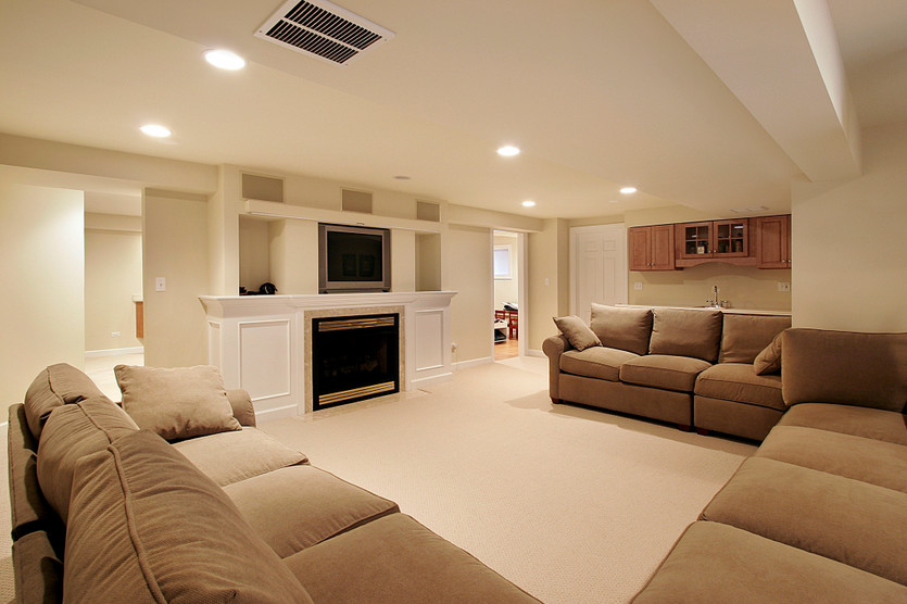 Example of a transitional look-out carpeted basement design in Chicago with beige walls, a standard fireplace and a stone fireplace