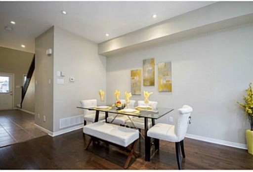 Mid-sized trendy medium tone wood floor and brown floor kitchen/dining room combo photo in Ottawa with beige walls and no fireplace