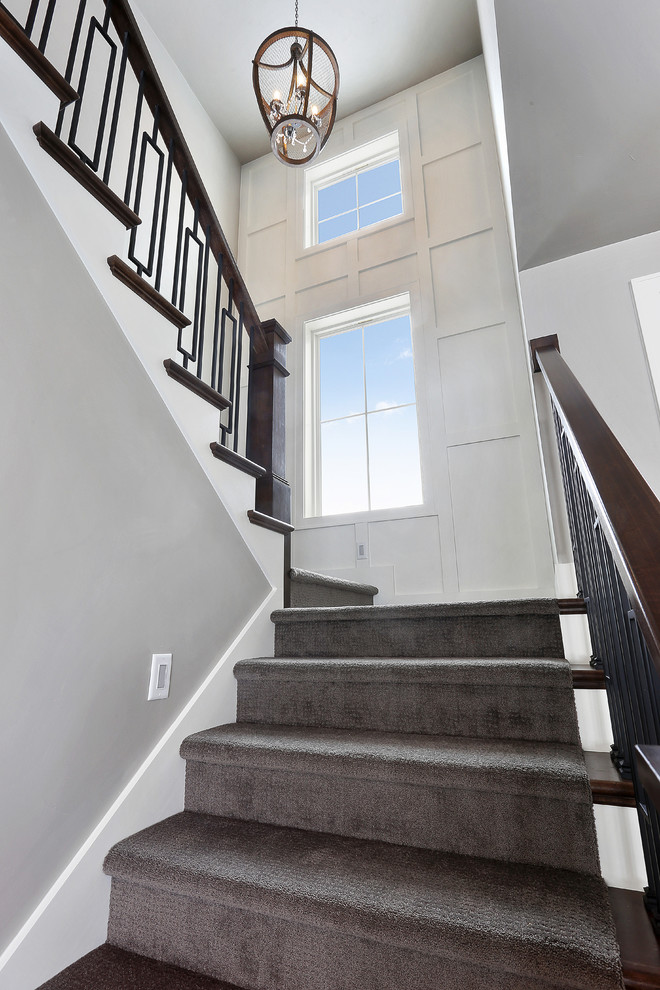 Inspiration for a transitional carpeted u-shaped mixed material railing staircase remodel
