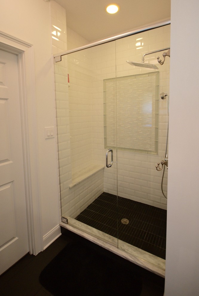 This is an example of a contemporary master bathroom in Atlanta with raised-panel cabinets, white cabinets, marble benchtops, a freestanding tub, an alcove shower, white tile, ceramic tile, white walls and ceramic floors.