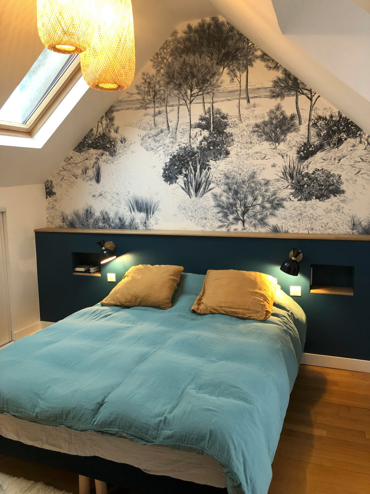 This is an example of a large contemporary master bedroom in Paris with blue walls, light hardwood floors, brown floor, exposed beam and wallpaper.
