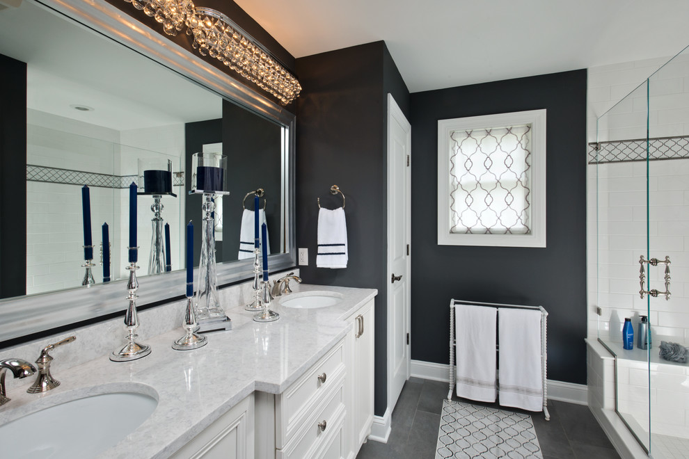 Inspiration for a beach style master bathroom in Boston with recessed-panel cabinets, white cabinets, multi-coloured tile, white tile, black walls, an undermount sink, grey floor and a hinged shower door.