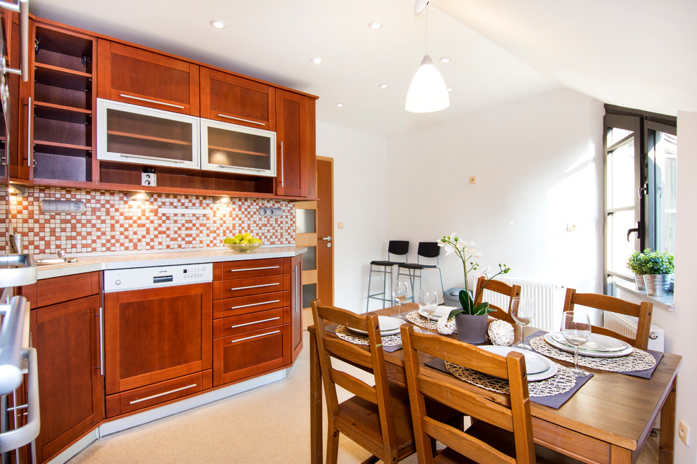 This is an example of a small eclectic l-shaped eat-in kitchen in Other with a single-bowl sink, recessed-panel cabinets, medium wood cabinets, laminate benchtops, orange splashback, mosaic tile splashback, stainless steel appliances, linoleum floors and no island.