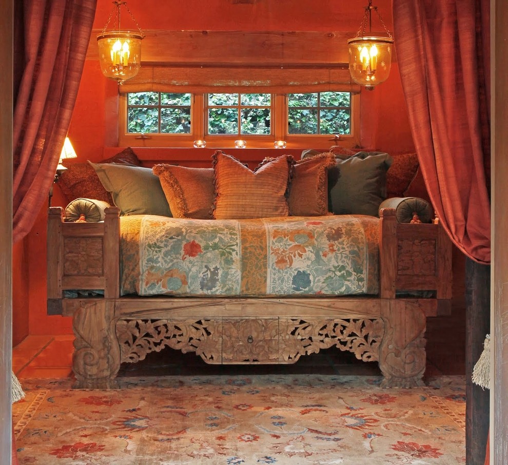 Photo of a mediterranean bedroom in Santa Barbara with orange walls.