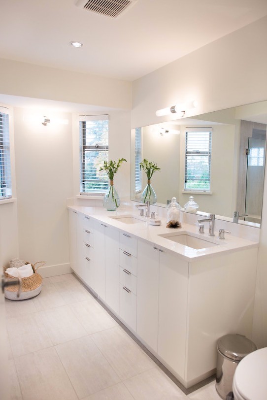Mid-sized scandinavian master bathroom in Vancouver with flat-panel cabinets, white cabinets, an alcove shower, a two-piece toilet, gray tile, ceramic tile, grey walls, ceramic floors, an undermount sink and engineered quartz benchtops.